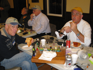 Dan  and Jeff taking care of some Chistmas pizza!